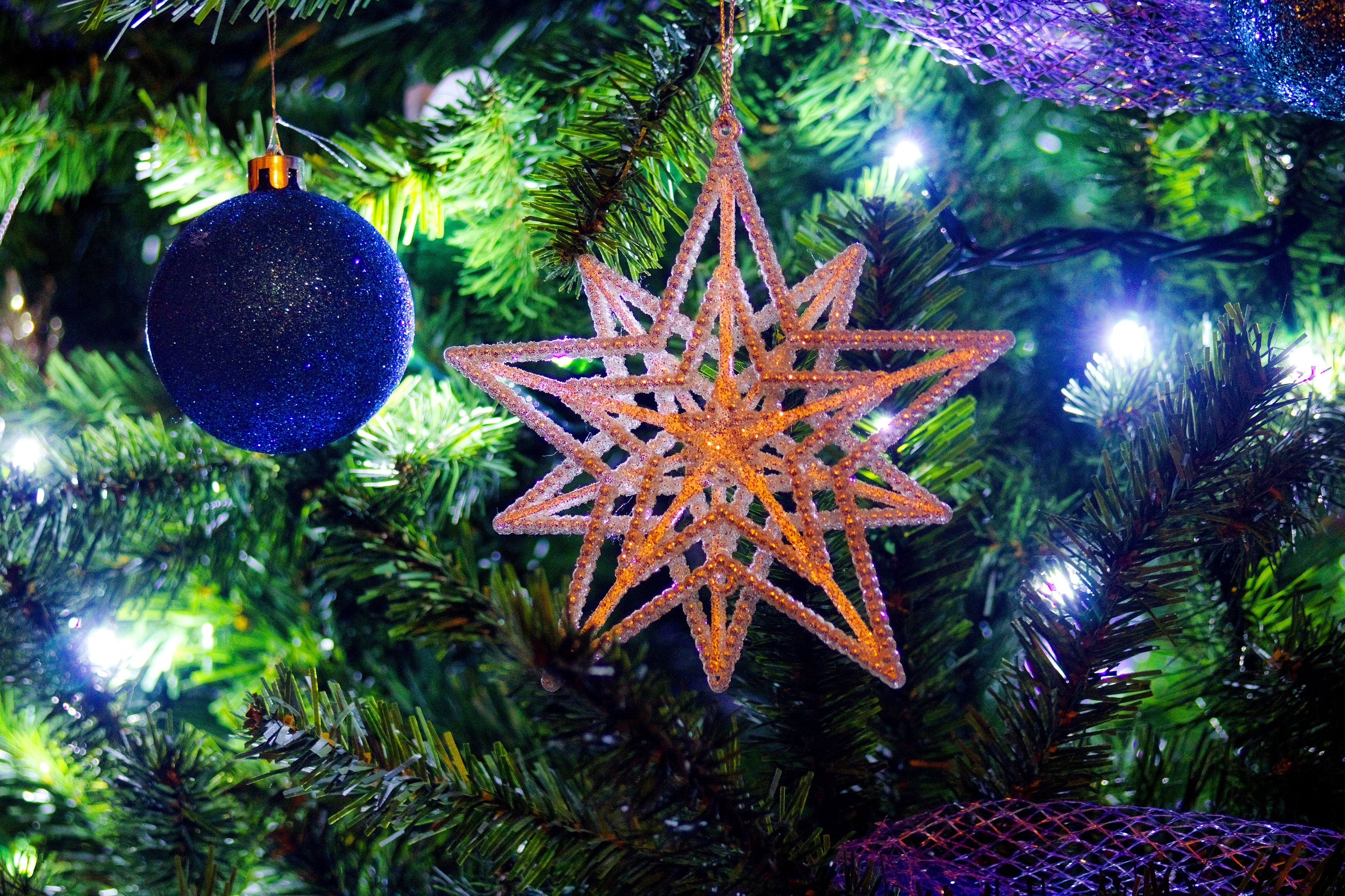 brown star christmas ornament with blue christams bauble