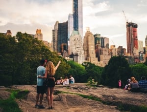 woman and man standing looking at the buildings thumbnail
