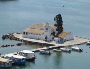 white concrete church on the middle of the water at daytime thumbnail