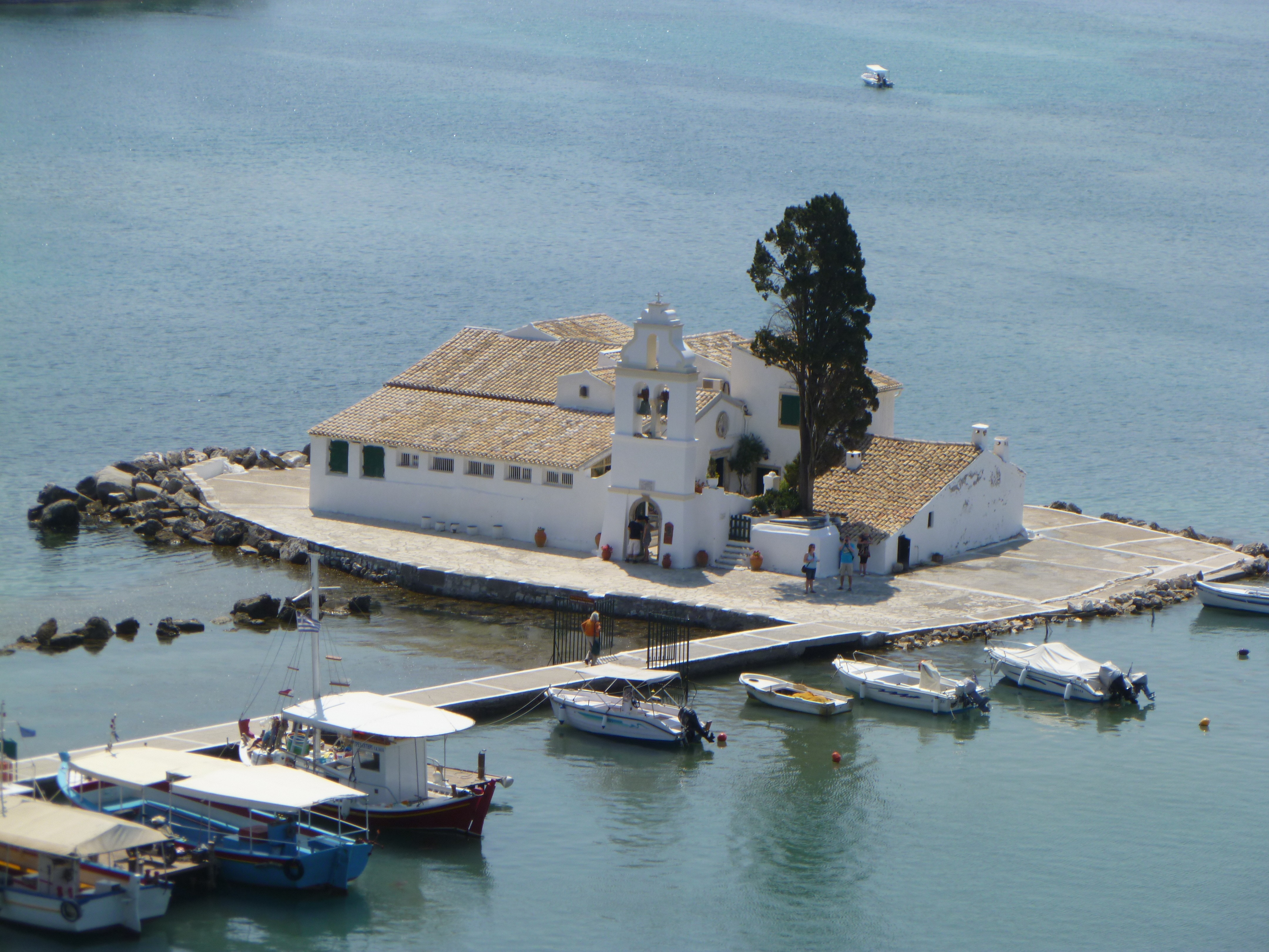 white concrete church on the middle of the water at daytime