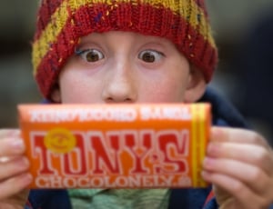 boy holding a tonnys chocolonely pack thumbnail