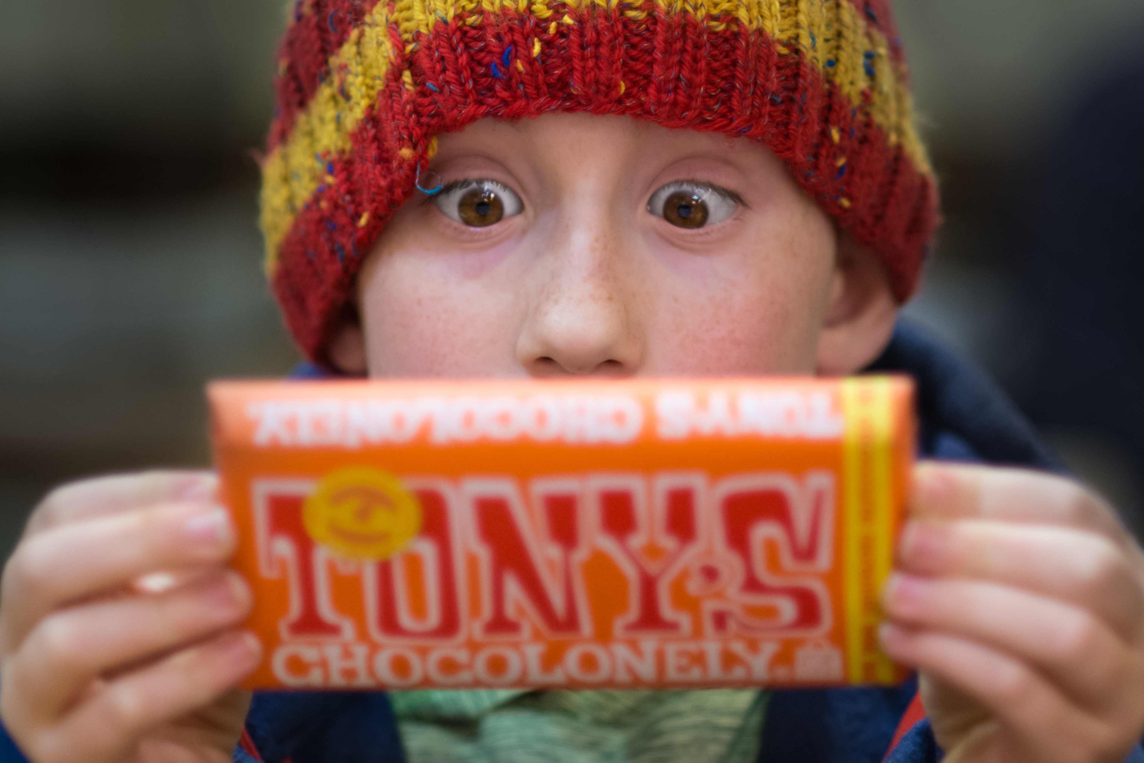boy holding a tonnys chocolonely pack