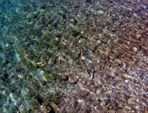 body of water with stones photography thumbnail