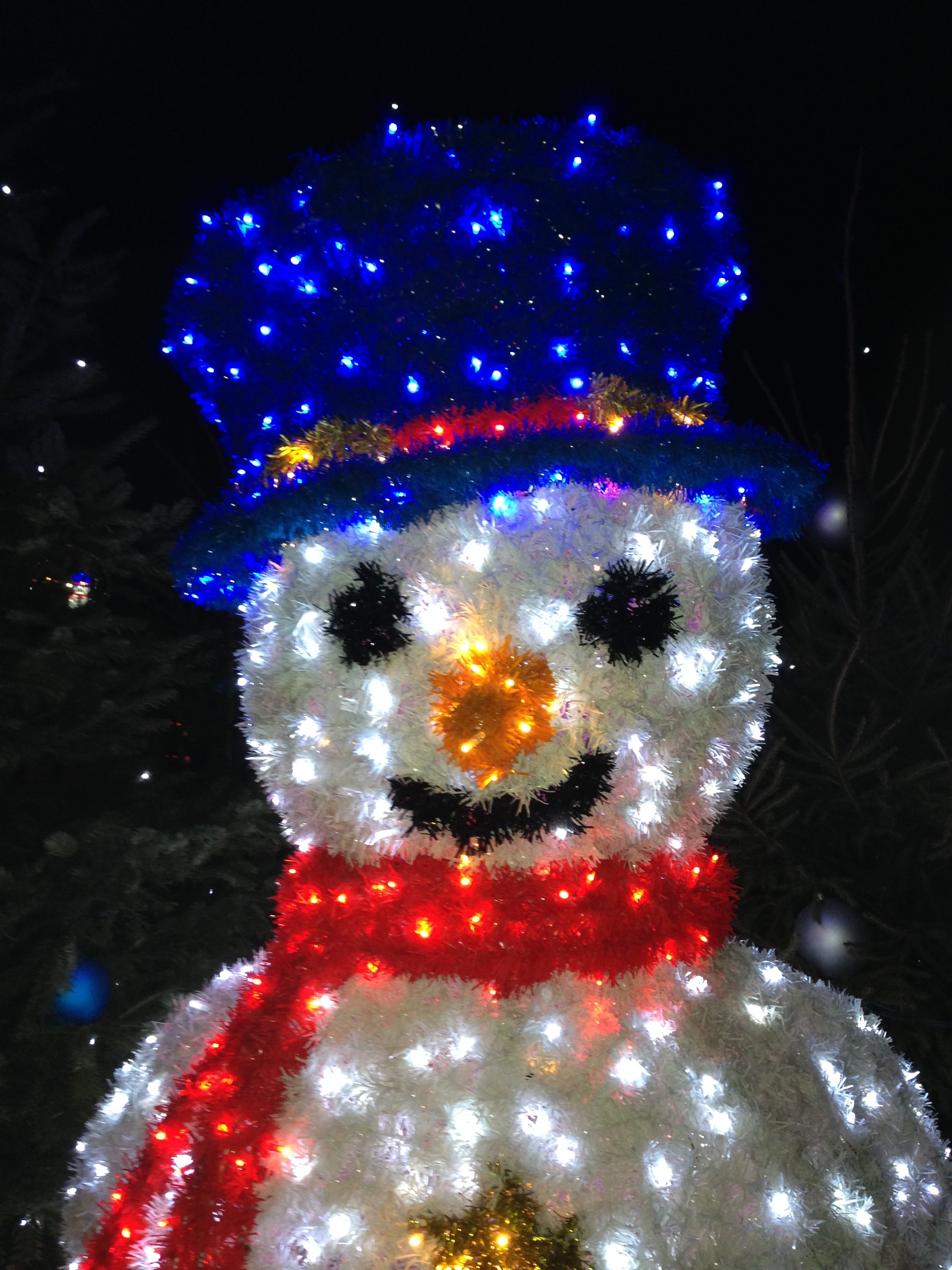 white blue and red snowman with scarf and hat statue