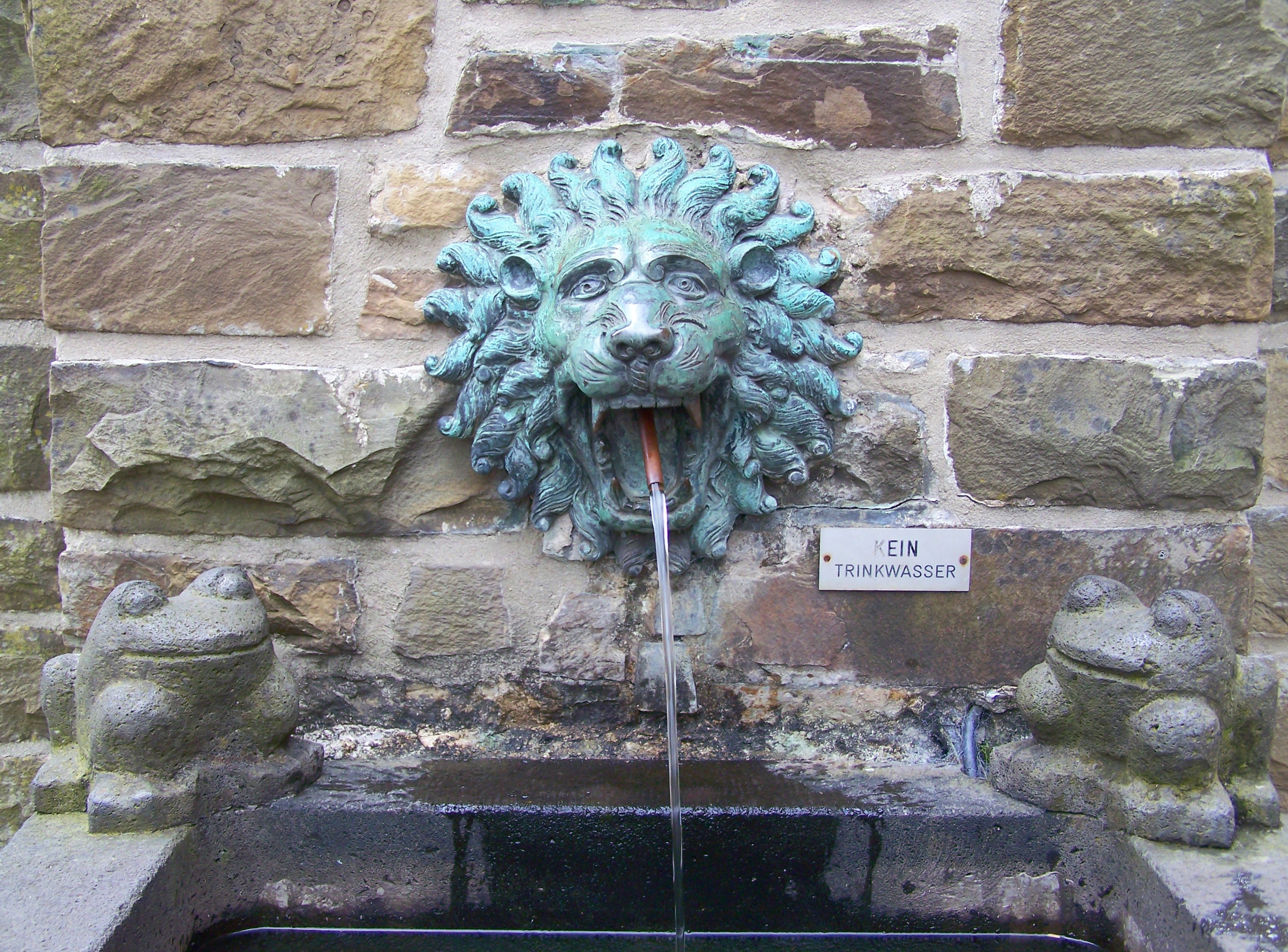 lion head concrete wall fountain