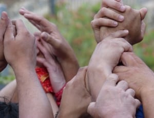 group of person holding hands thumbnail