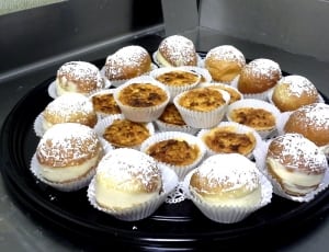 cupcakes with powered sugar on black plate thumbnail