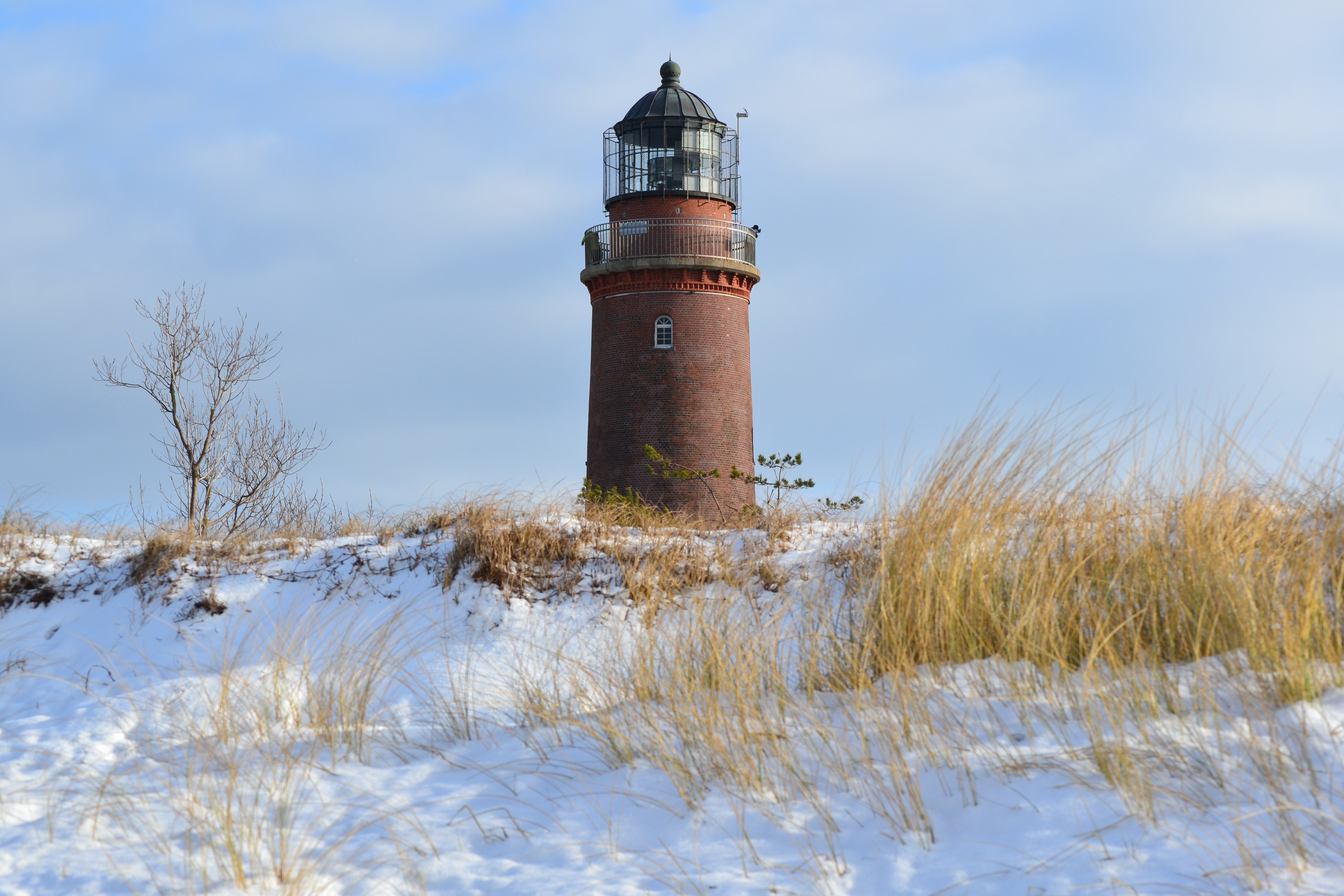 brown lighthouse surrounded by snow