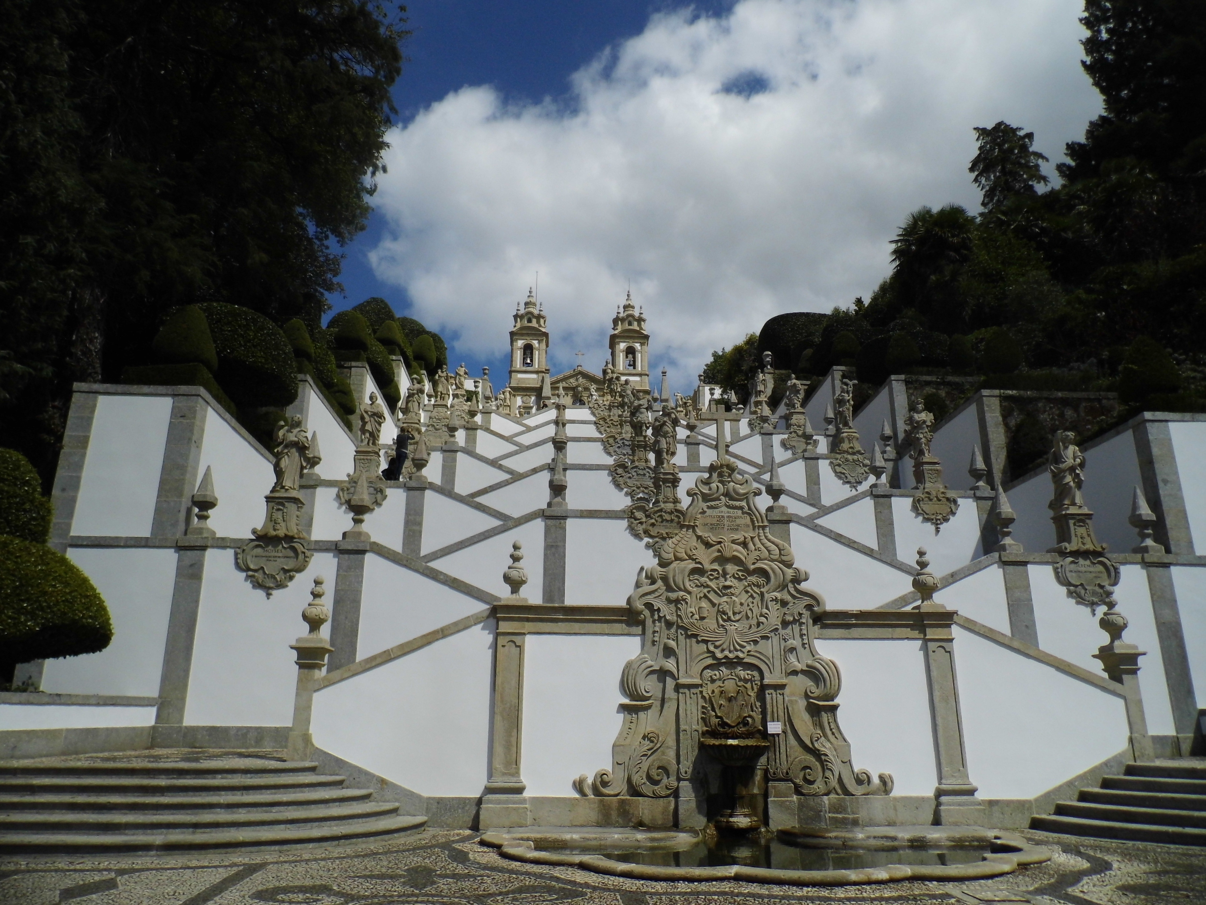 gray statue and white staircase