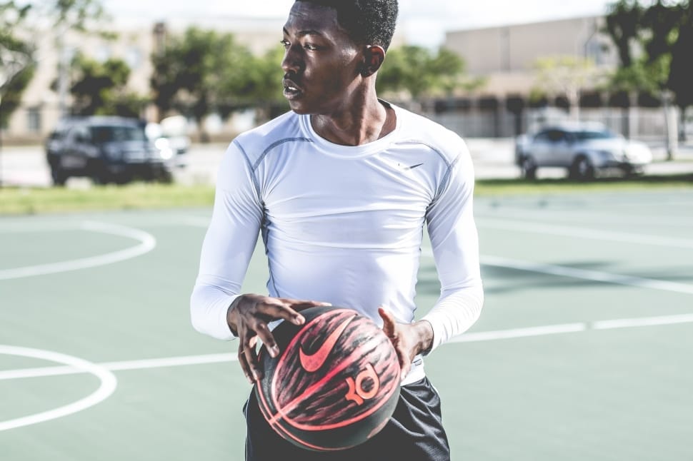 man playing basketball at open court preview