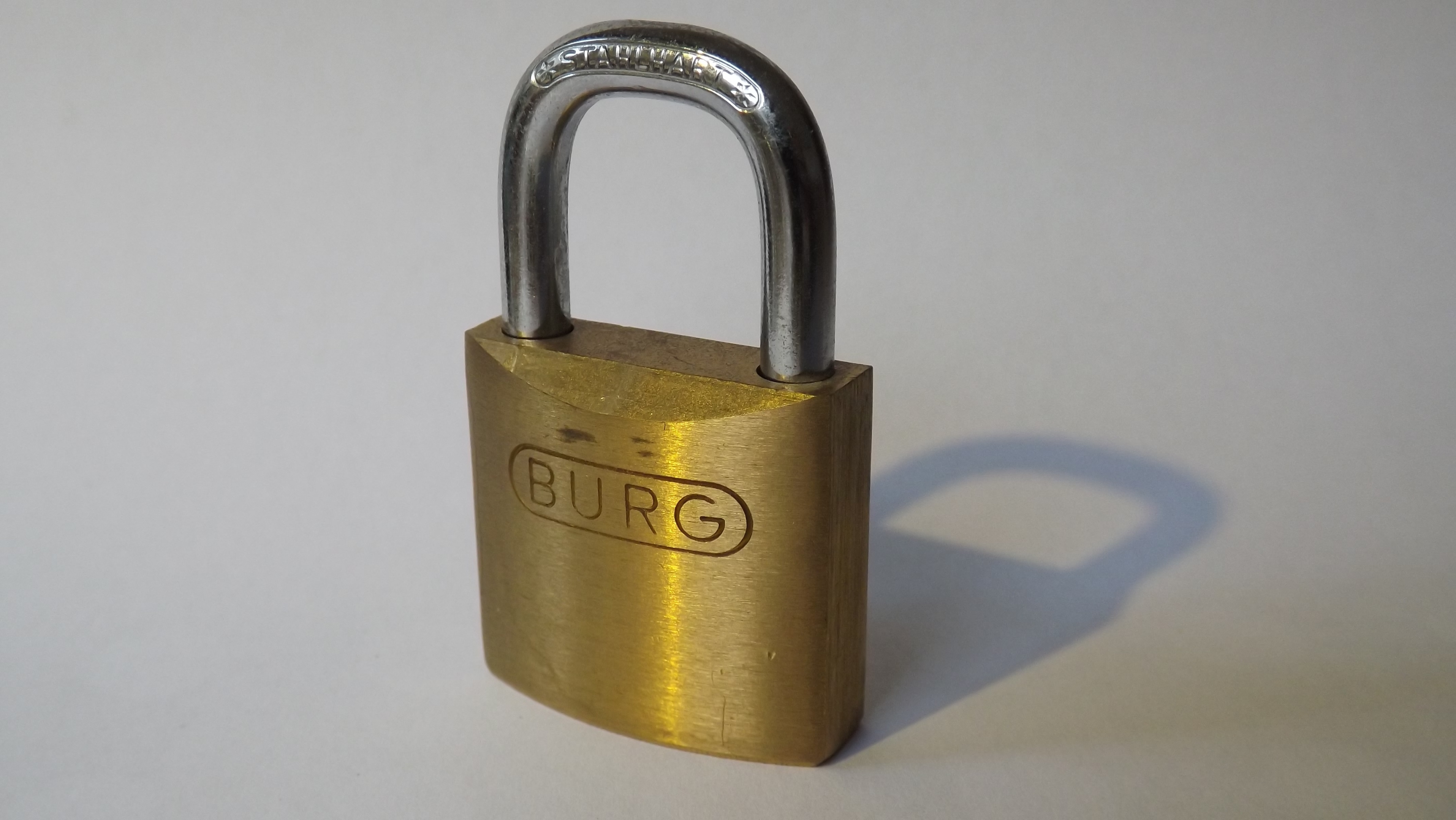 brass and silver burg padlock