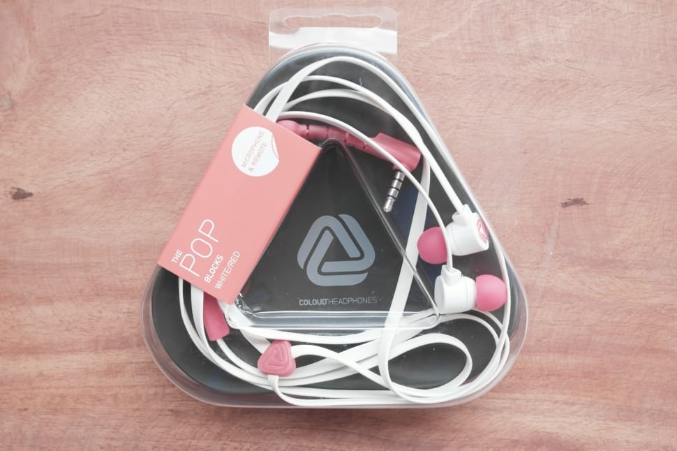 pink and white pop earphones in plastic pack preview