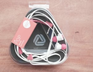 pink and white pop earphones in plastic pack thumbnail