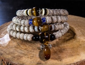 4 brown and white beaded bracelets thumbnail