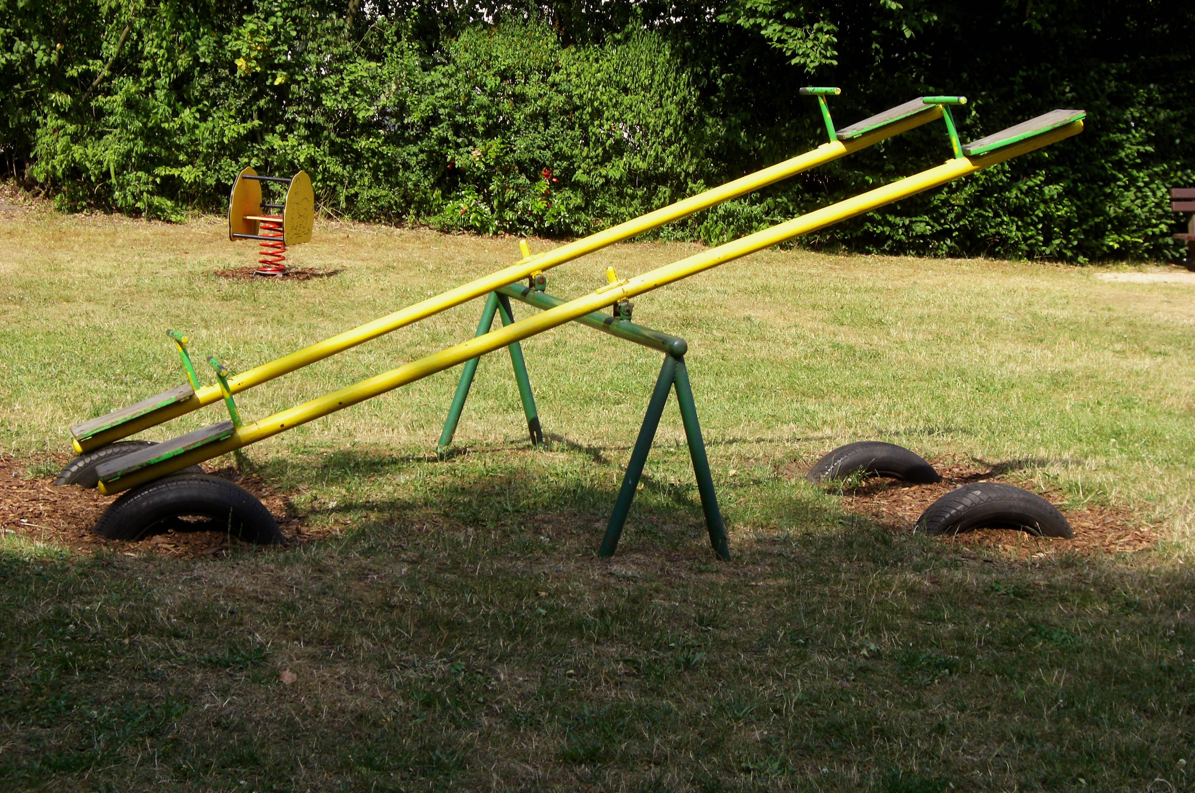 2 yellow and green seesaws