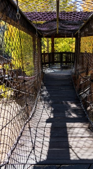 brown wooden bridge with net thumbnail