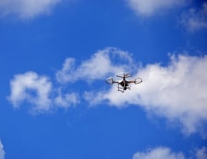 white quadcopter in flight during daytime thumbnail