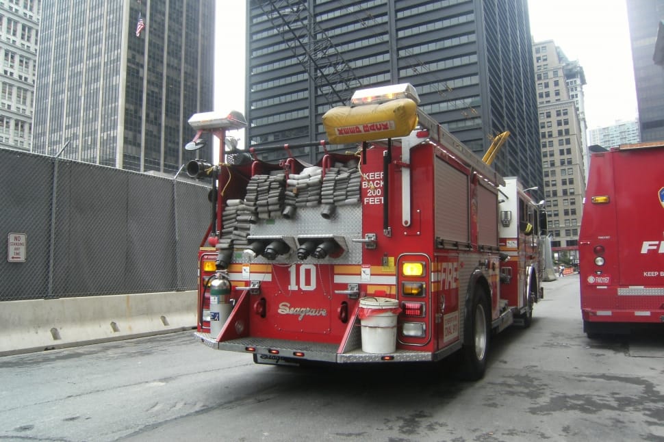 red and gray firetruck near gray concrete building during daytime preview