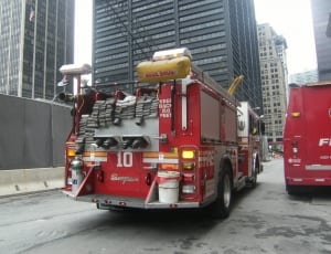 red and gray firetruck near gray concrete building during daytime thumbnail