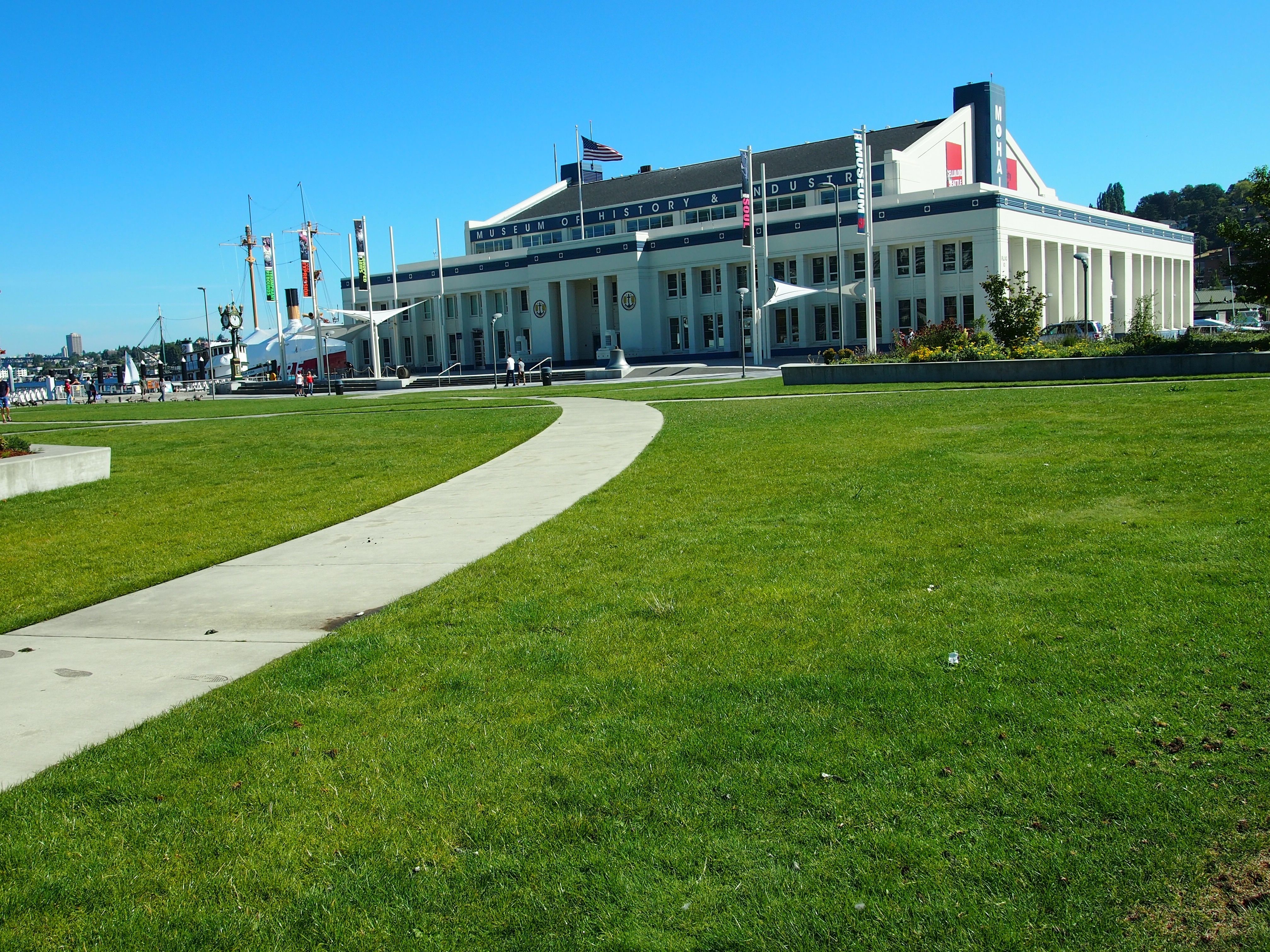 white and grey concrete building with green grass field