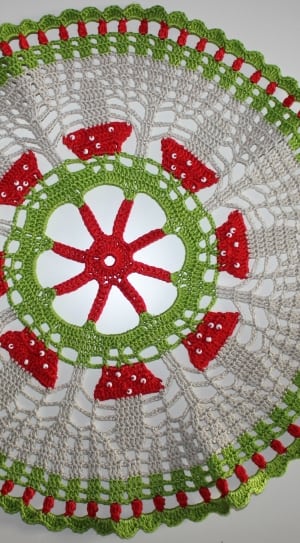 gray, red, and green knitted doily thumbnail