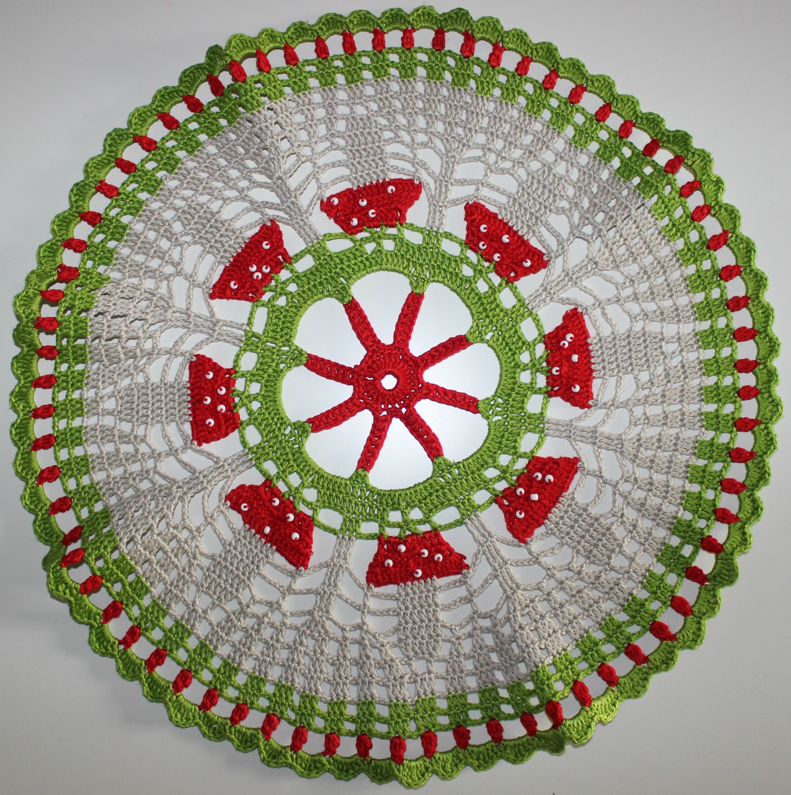 gray, red, and green knitted doily