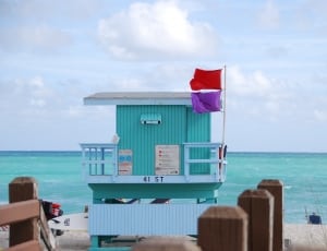 green and white wooden life guard watch tower thumbnail