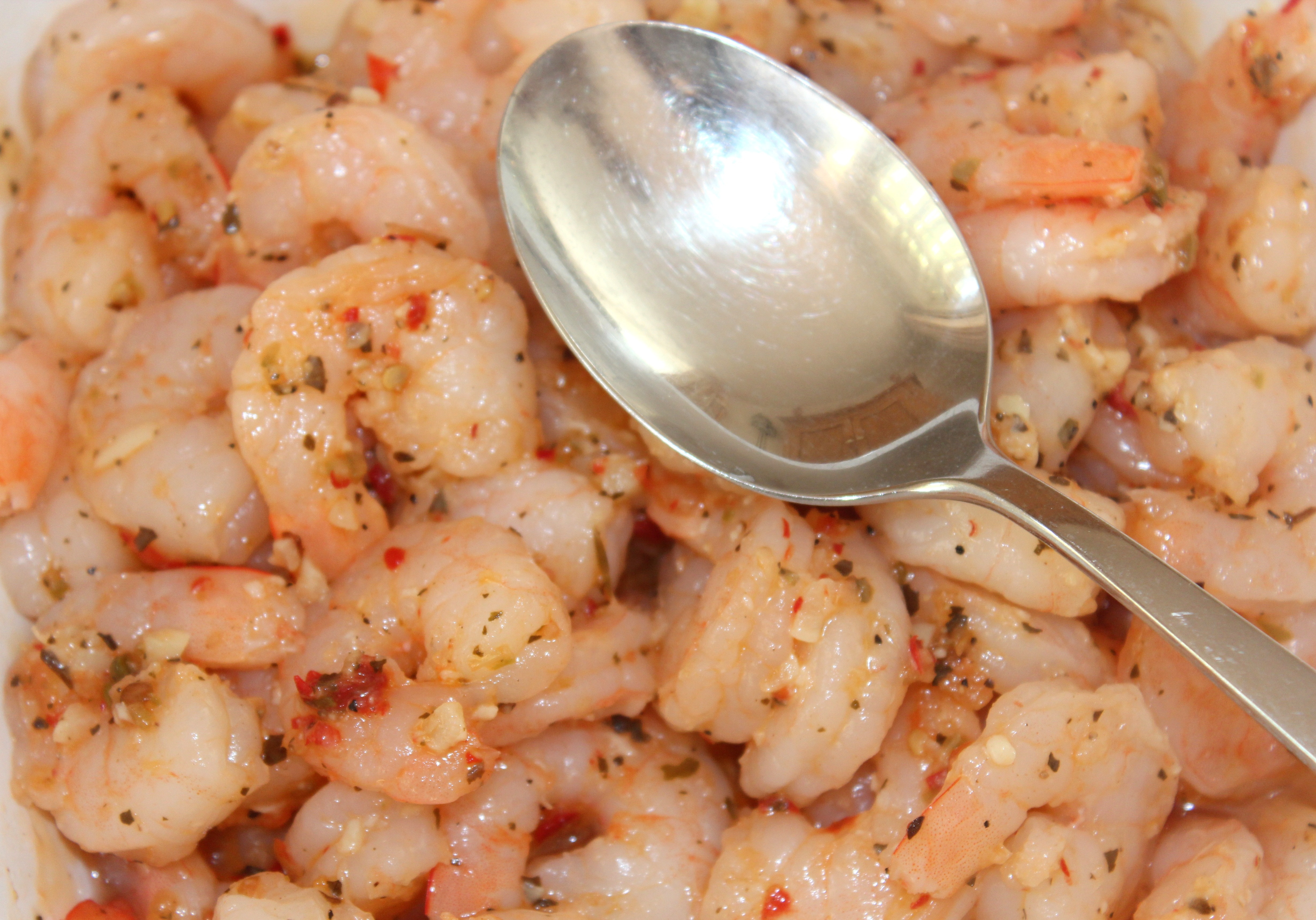 cooked shrimps and stainless steel spoon