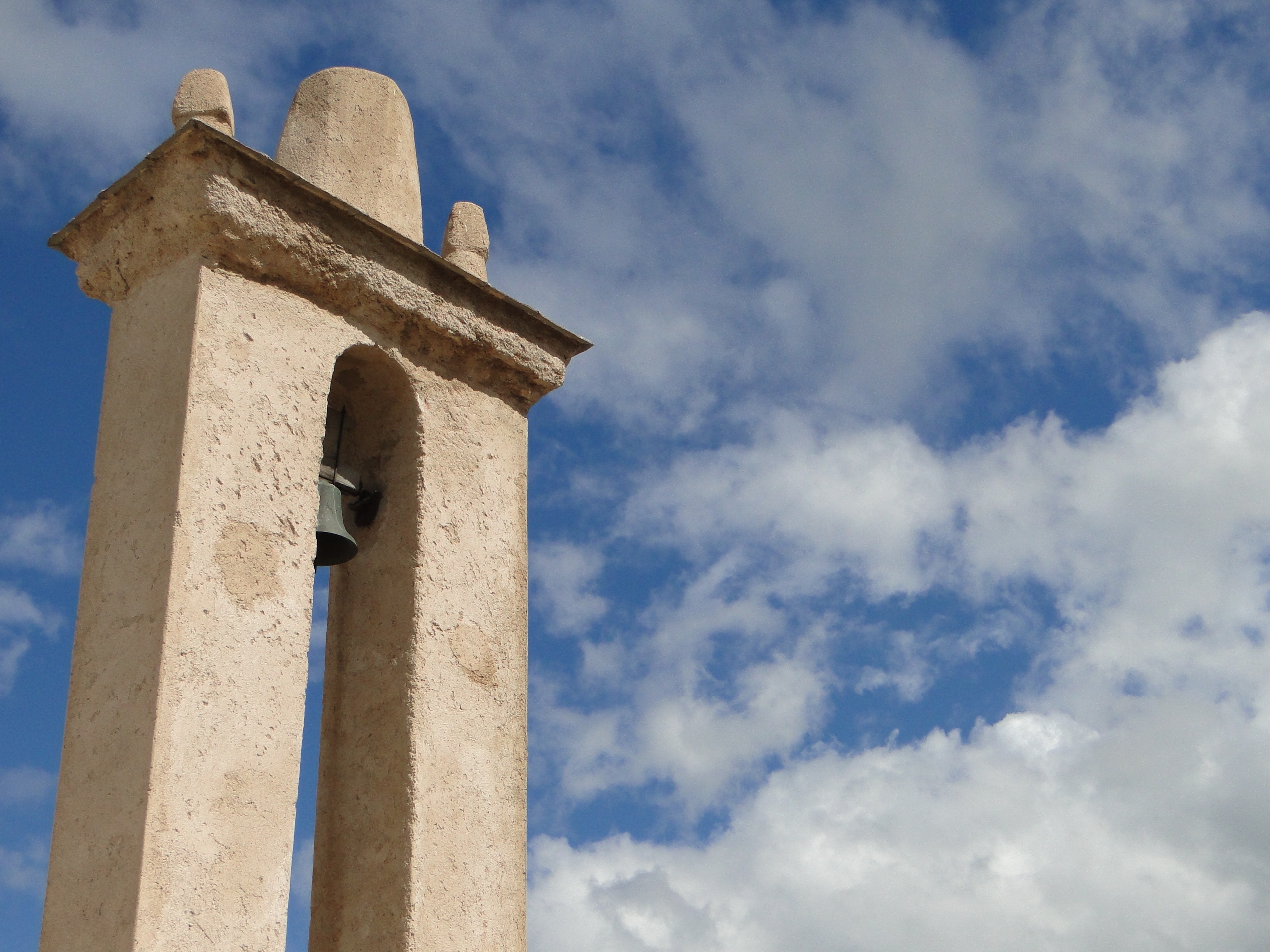 white concrete bell tower near the sky during daytime