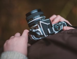 person holding grey and black dslr thumbnail