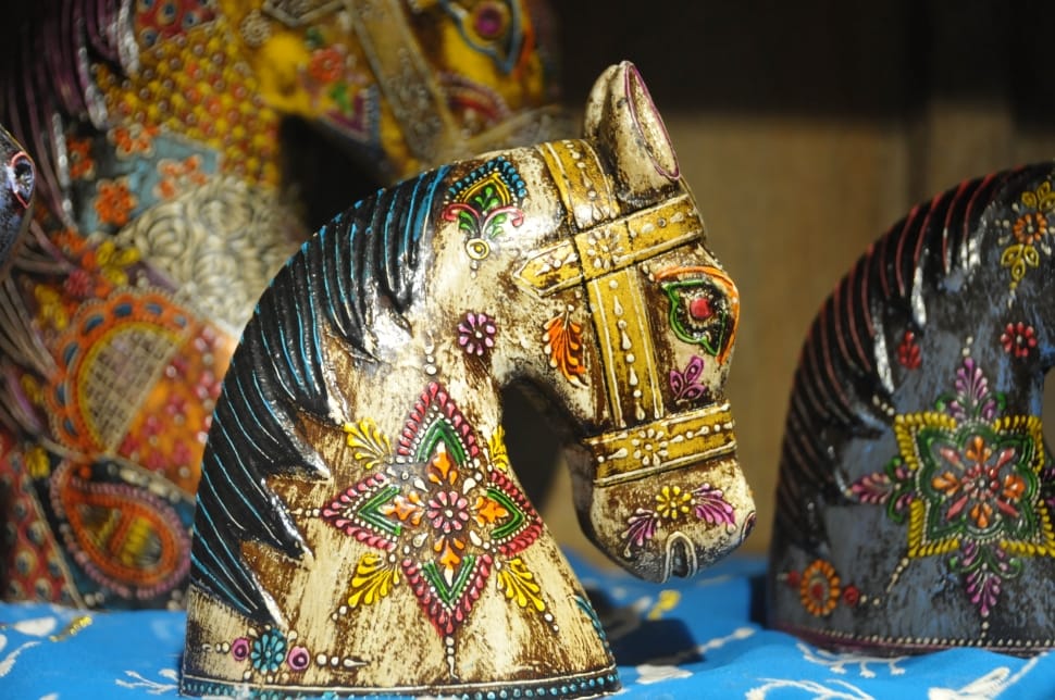 yellow pink and black wooden horse figurine preview