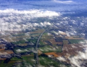 top view photo of greenfield and road at daytime thumbnail