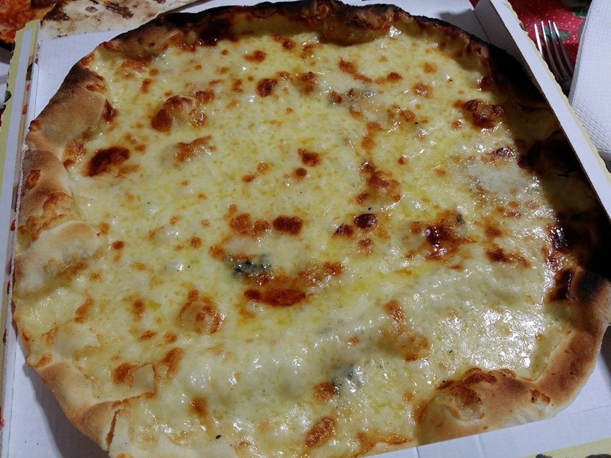 cheesy pizza in box