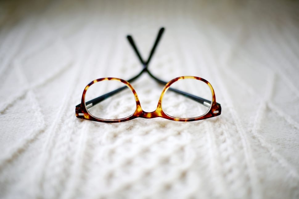 tortoise frame eyeglasses on white textile preview