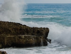 sea waves bumping on brown rock thumbnail