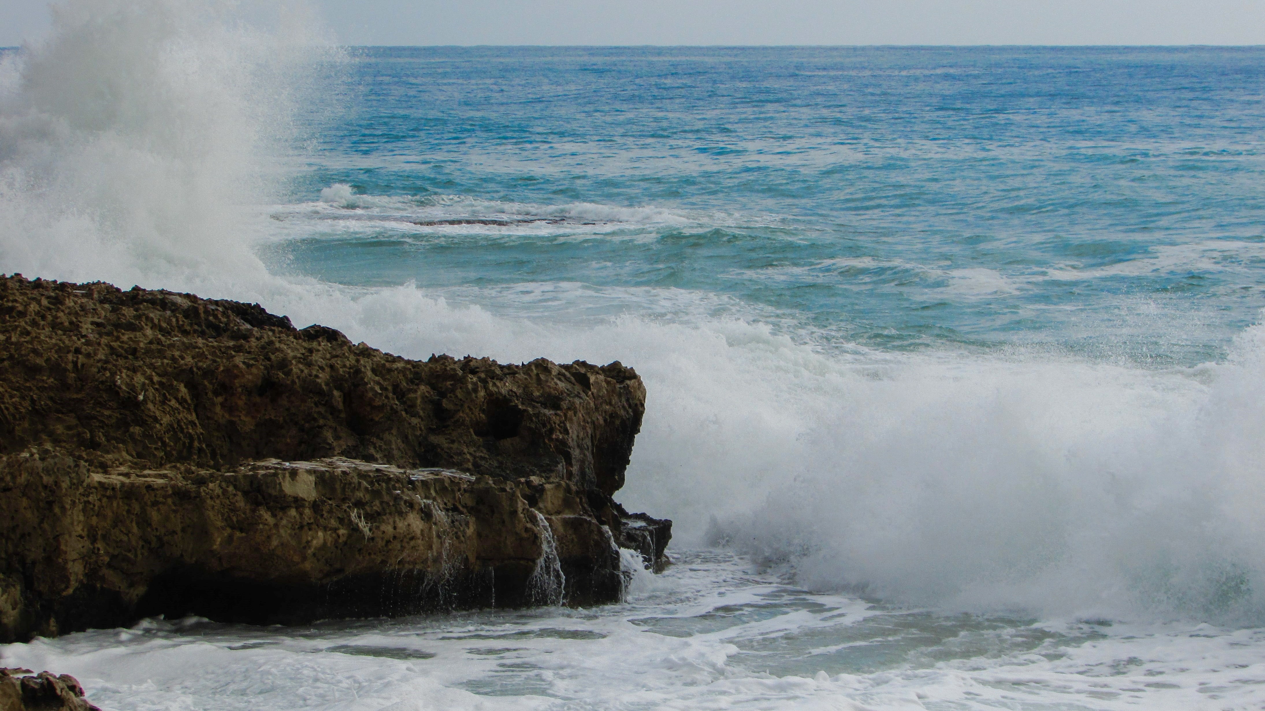 sea waves bumping on brown rock
