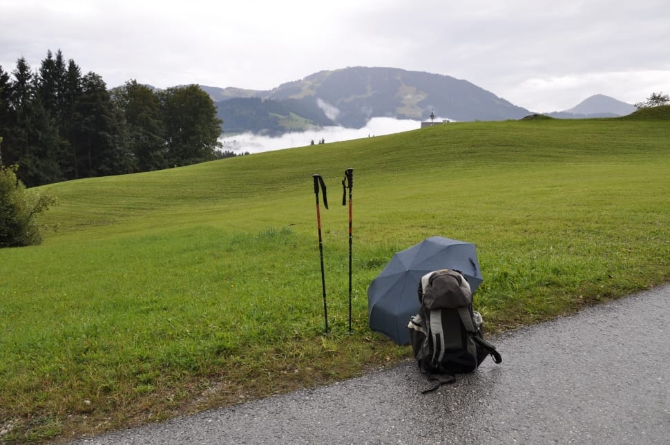 black umbrella and hiking backpack preview