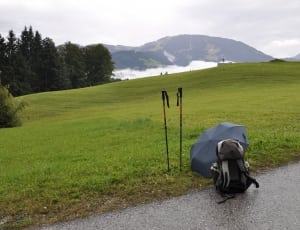 black umbrella and hiking backpack thumbnail
