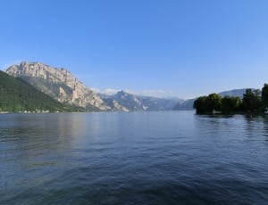 photo of mountain near lake during daytime thumbnail
