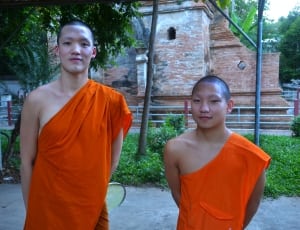 two monks in orange clothing thumbnail