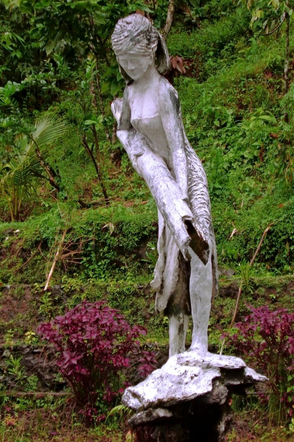 statue of woman carrying log preview