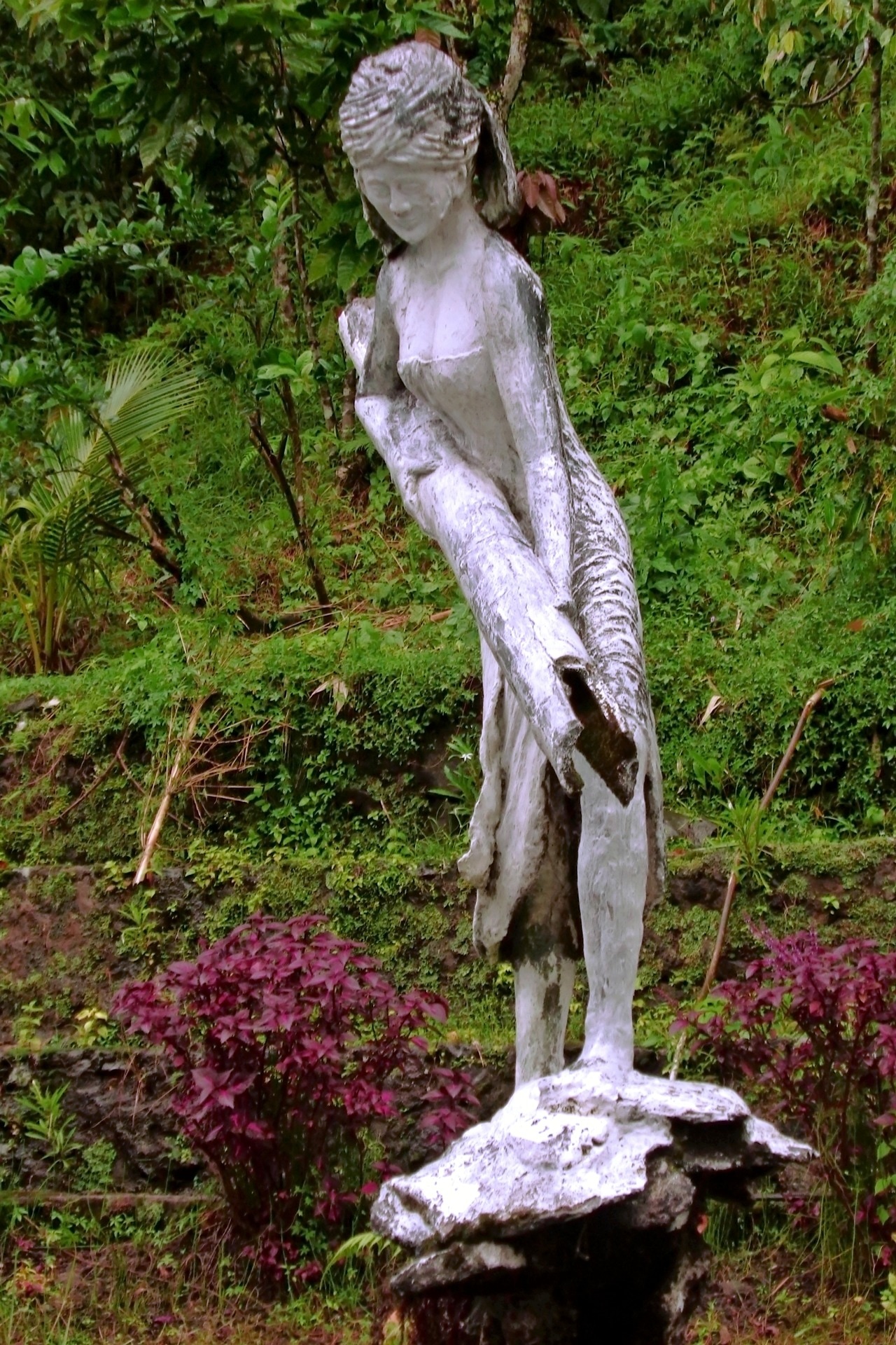 statue of woman carrying log