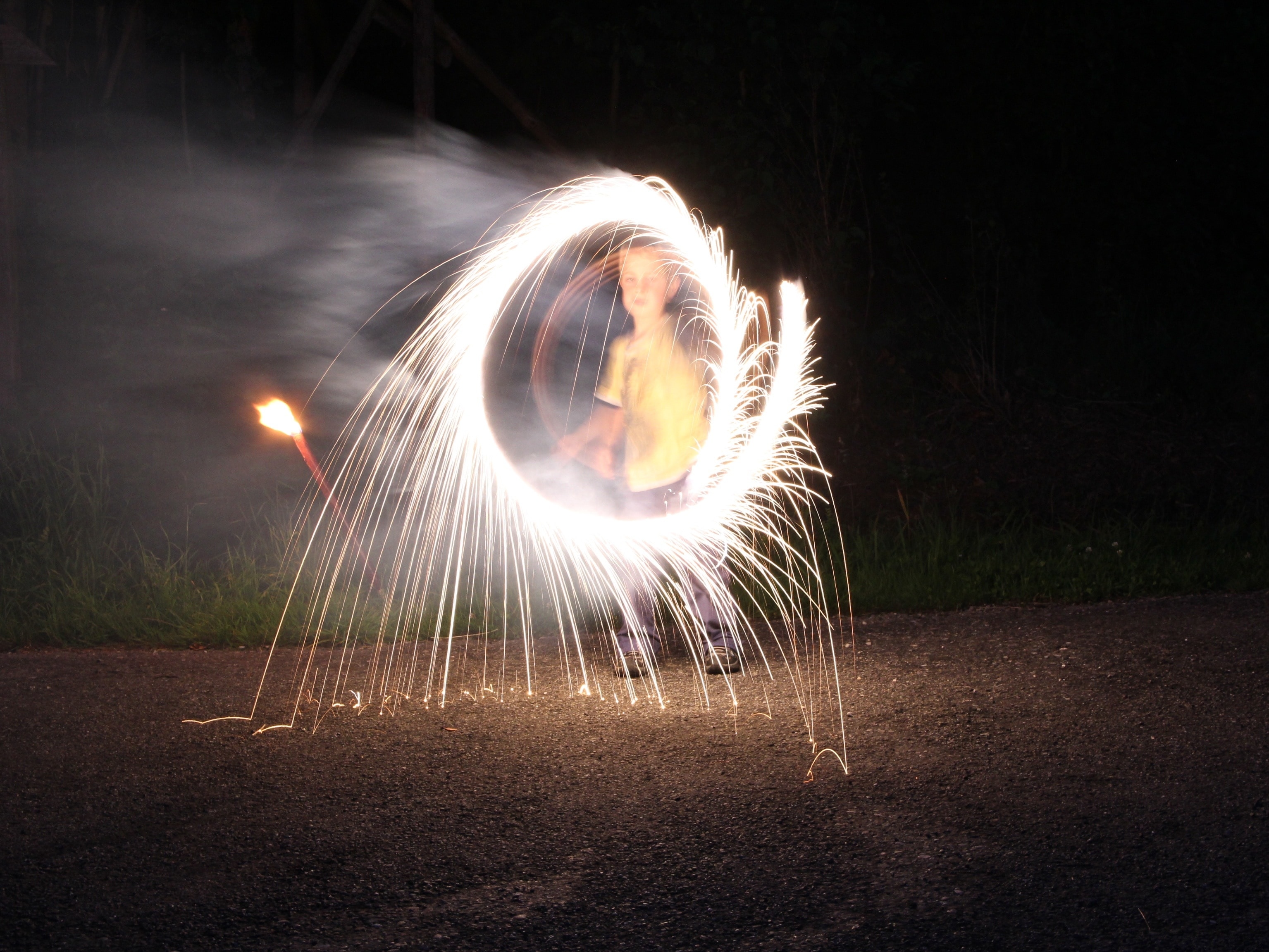 child playing with fireworks at night