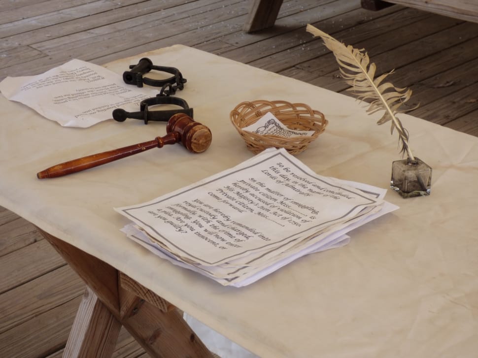 brown judge wooden hammer and feather pen preview