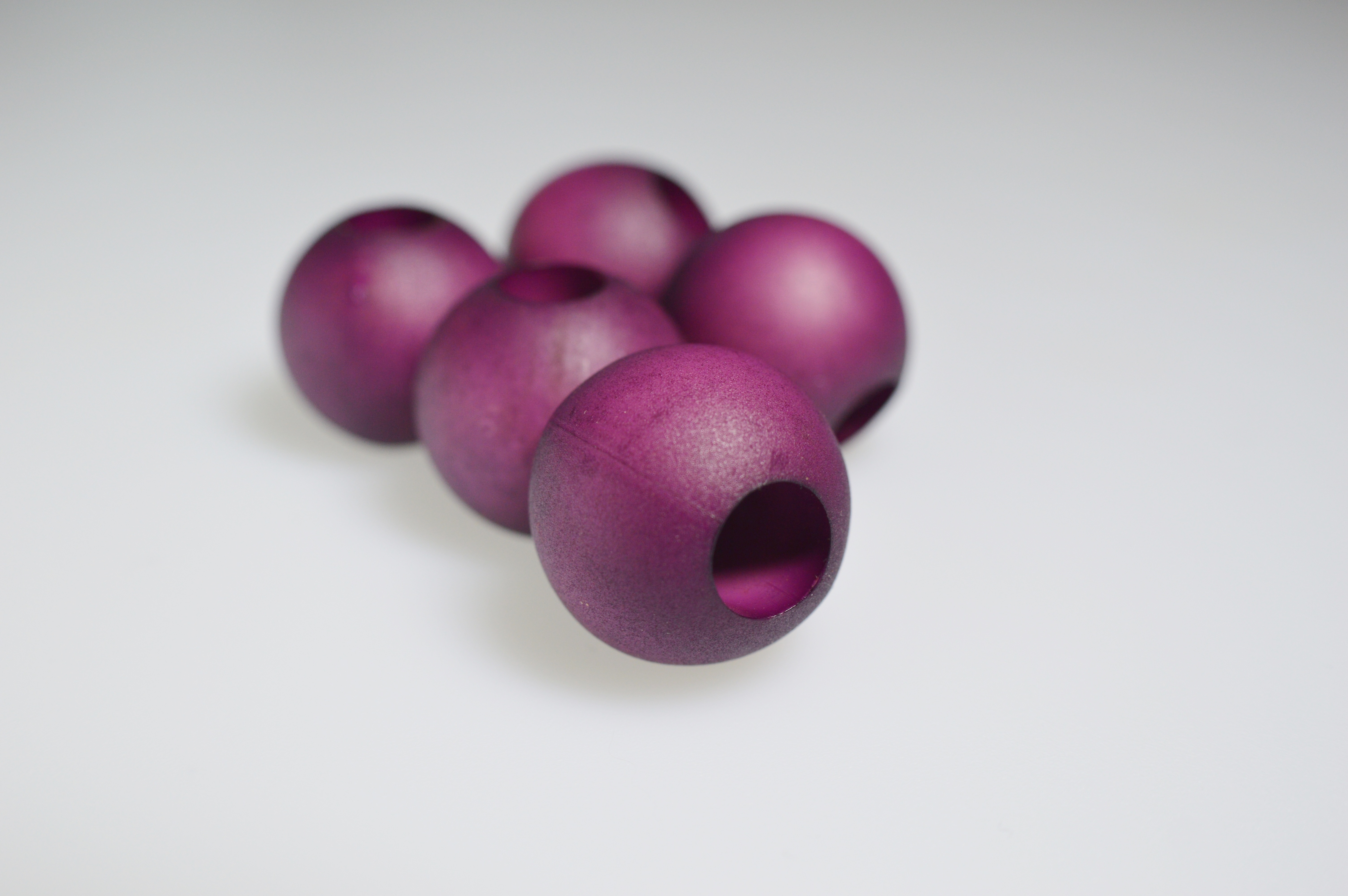 five purple wooden beads