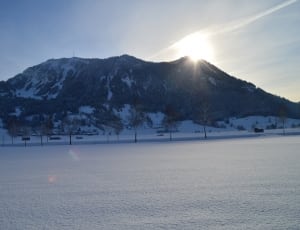 mountains covered with snow under white clouds thumbnail