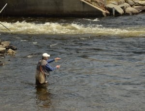 man casting fishing rod in river thumbnail