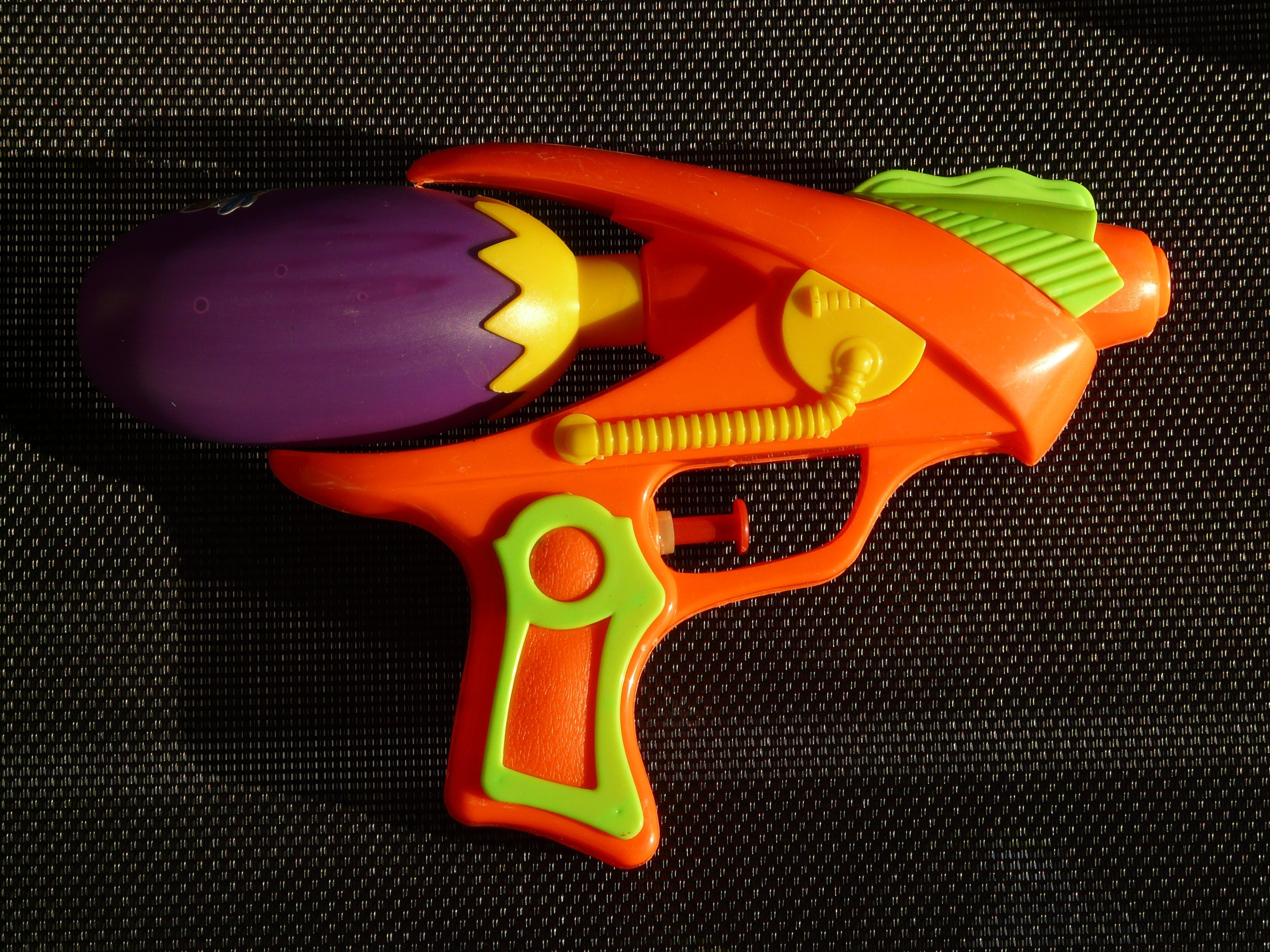 orange and purple plastic water gun
