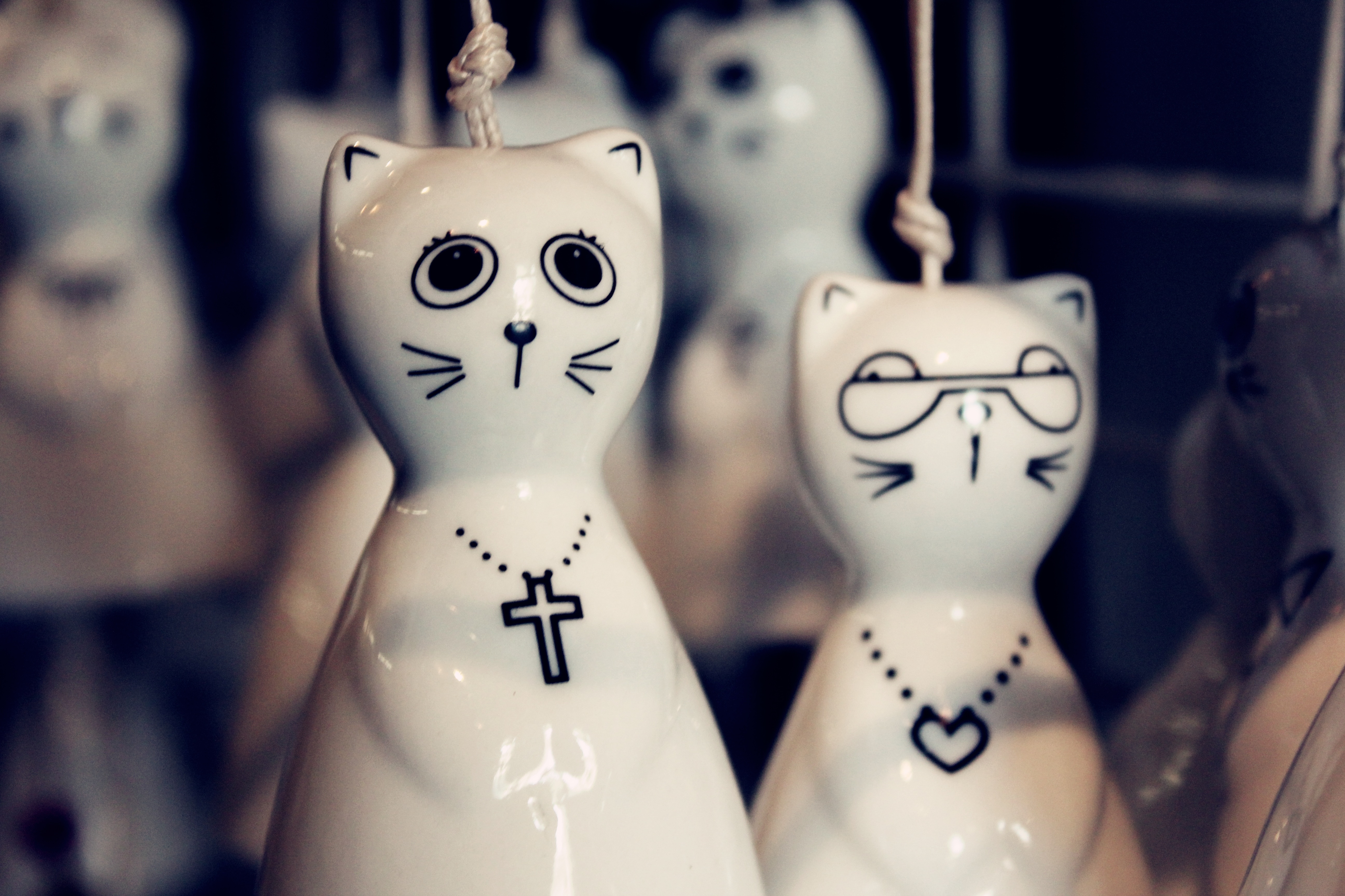 2 white ceramic cat figurines