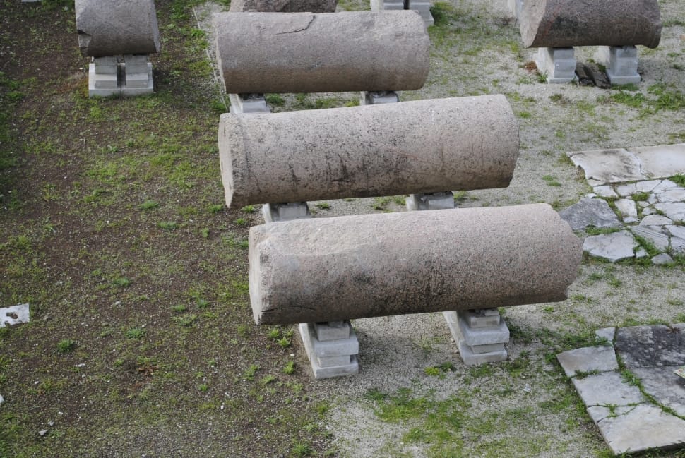 three cylindrical concrete on top of white concrete preview